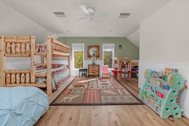 bedroom with ceiling fan, vaulted ceiling, and light wood-type flooring