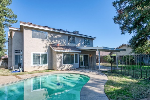 back of property with a patio, fence, a fenced in pool, and stucco siding