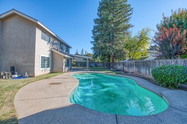 view of swimming pool with a fenced in pool, a yard, a fenced backyard, and a patio area