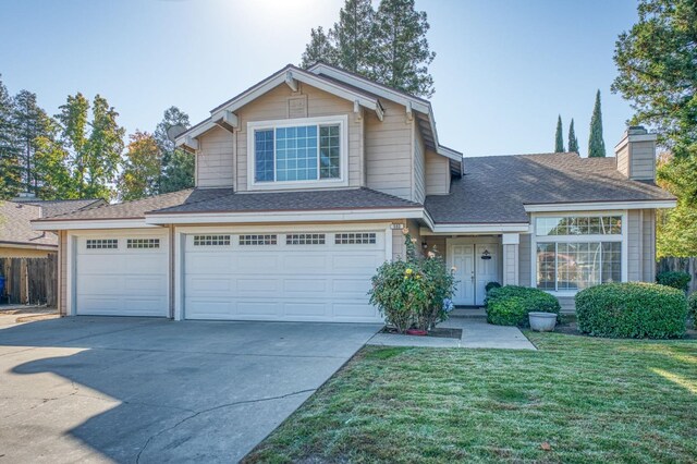 view of front of home with a garage and a front lawn