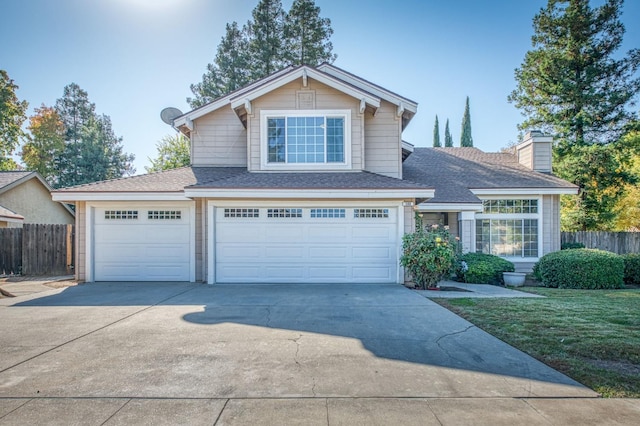 traditional-style house with driveway, a chimney, a front lawn, and fence