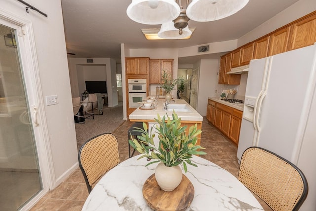 dining room with sink and light tile patterned floors