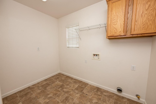 clothes washing area with cabinets and washer hookup