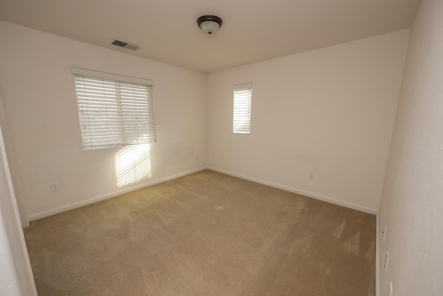 unfurnished room with light colored carpet