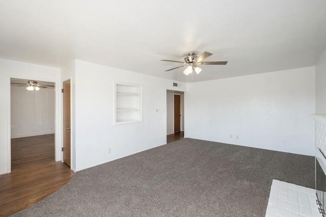 unfurnished room featuring dark carpet and ceiling fan