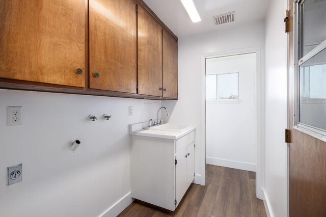 laundry room featuring dark wood-type flooring, sink, cabinets, washer hookup, and hookup for an electric dryer