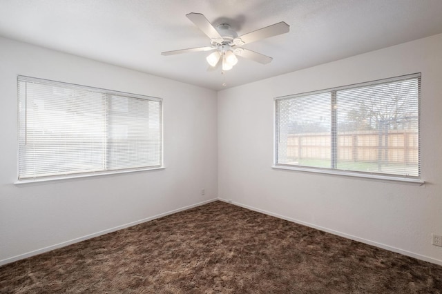 carpeted spare room with ceiling fan