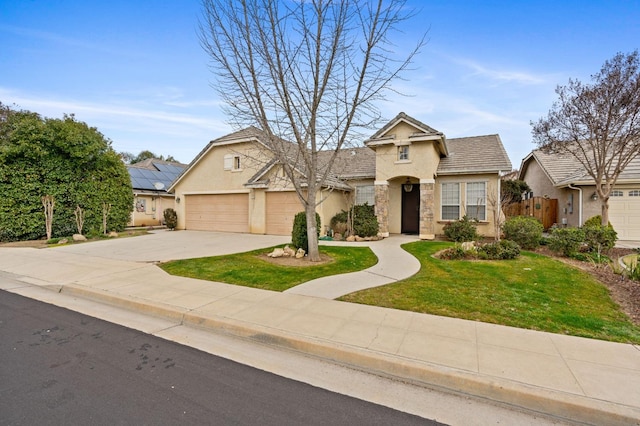 view of front of property featuring a garage and a front lawn