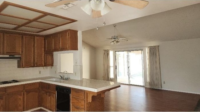 kitchen featuring black dishwasher, sink, backsplash, ceiling fan, and kitchen peninsula