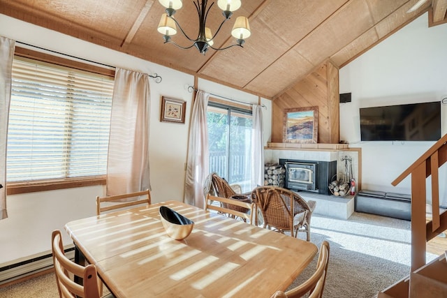 dining room with an inviting chandelier, lofted ceiling, carpet, and a wood stove