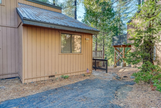 view of home's exterior with a wooden deck