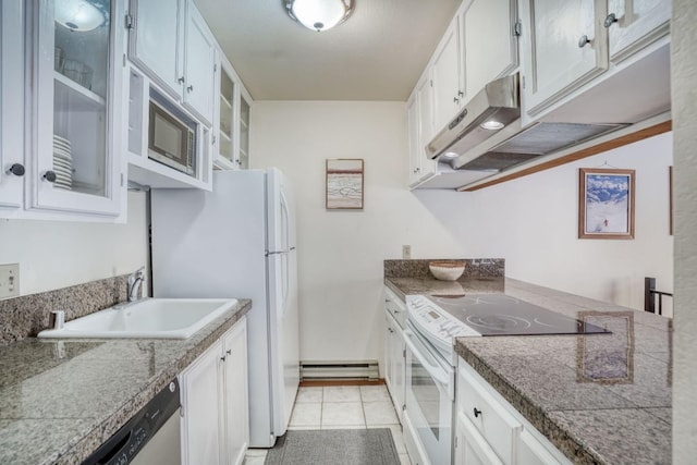 kitchen with white cabinetry, sink, light tile patterned floors, and appliances with stainless steel finishes