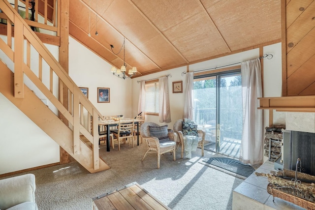 carpeted living room with a tiled fireplace, high vaulted ceiling, wood ceiling, and an inviting chandelier