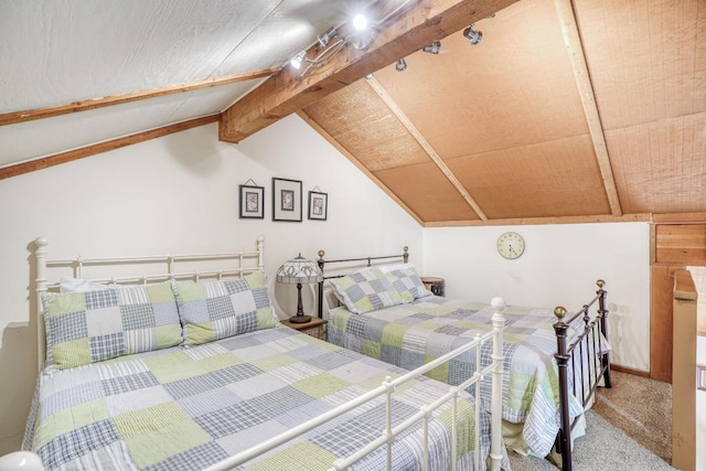 carpeted bedroom with vaulted ceiling with beams