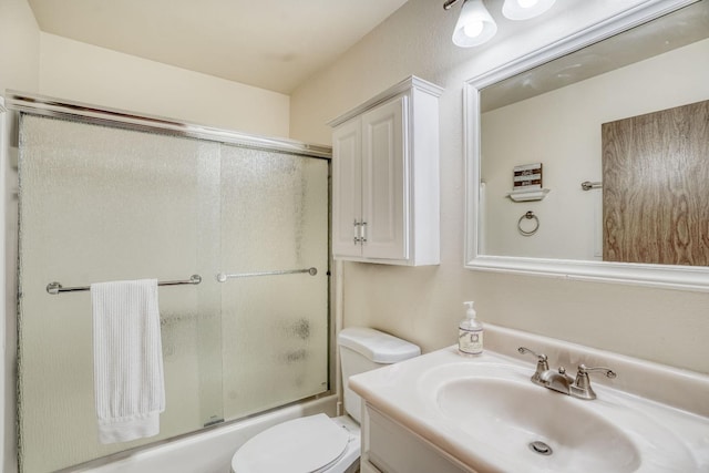 full bathroom with toilet, vanity, and shower / bath combination with glass door