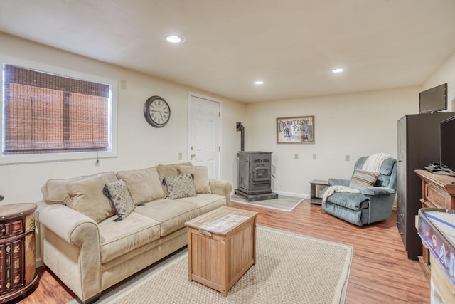 living room with light wood-type flooring and a wood stove