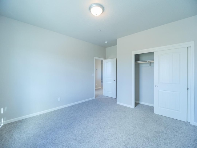 unfurnished bedroom featuring carpet floors and a closet