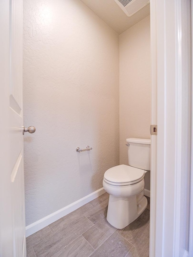 bathroom featuring toilet and hardwood / wood-style floors