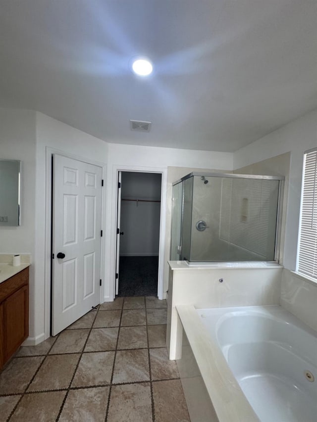 bathroom featuring vanity and shower with separate bathtub