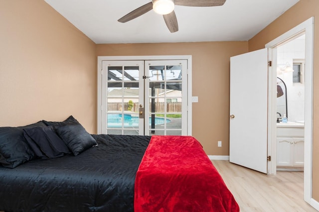 bedroom featuring french doors, sink, light hardwood / wood-style flooring, access to outside, and ceiling fan