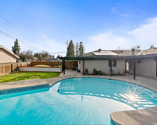 view of pool with a lawn