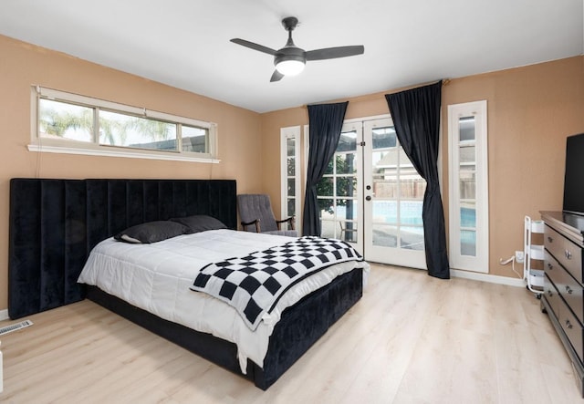 bedroom featuring access to outside, light wood-style floors, and baseboards