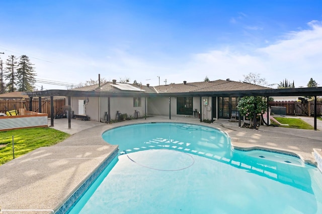 view of swimming pool with a patio and fence