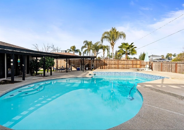 view of swimming pool featuring a fenced backyard and a patio