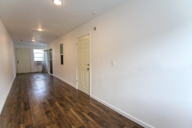 hall featuring dark wood-style floors, cooling unit, and baseboards
