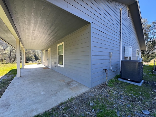 view of side of home with central AC