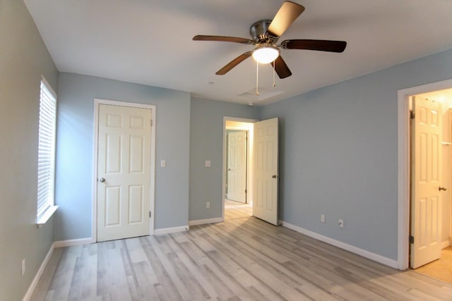 unfurnished bedroom featuring baseboards, ceiling fan, and light wood-style floors