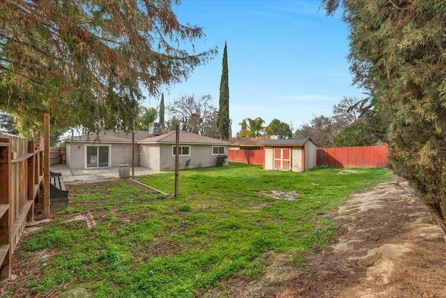 view of yard with a patio, a storage unit, an outdoor structure, and a fenced backyard