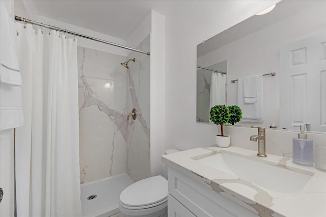 full bathroom featuring toilet, a shower stall, and vanity