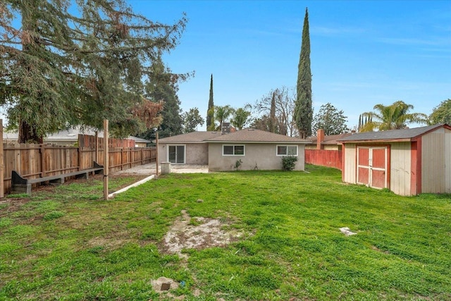 back of property featuring a storage shed, a fenced backyard, a lawn, and an outdoor structure