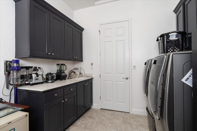 laundry area with light tile patterned floors and washing machine and clothes dryer