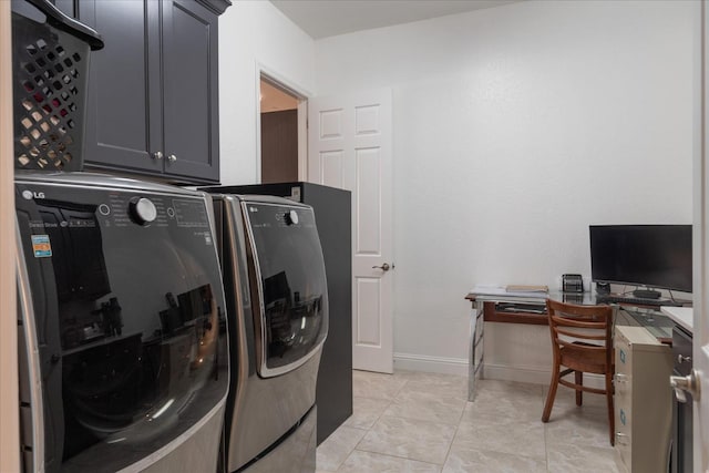 laundry area featuring cabinets, light tile patterned floors, and independent washer and dryer