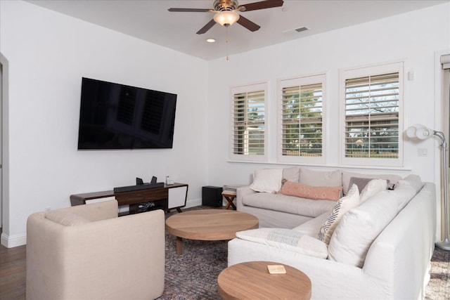 living room featuring dark wood-type flooring and ceiling fan