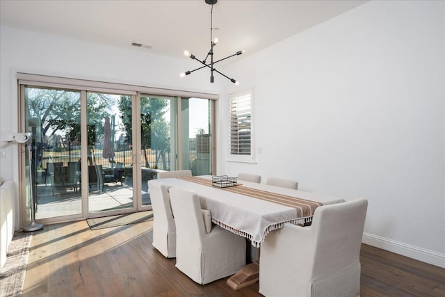 dining space featuring an inviting chandelier and dark hardwood / wood-style floors