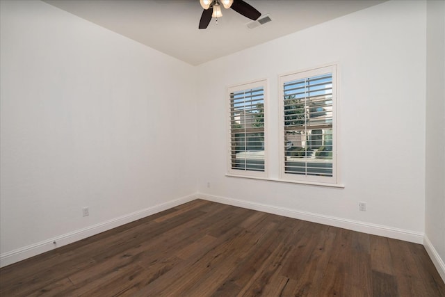 empty room featuring dark wood-type flooring and ceiling fan