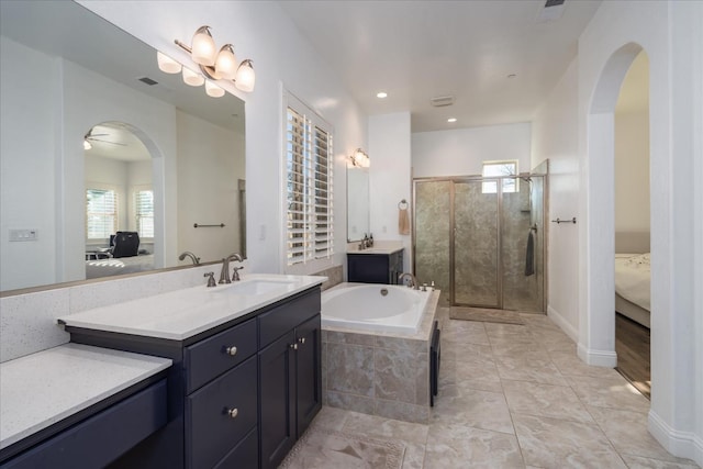 bathroom with vanity, a wealth of natural light, and plus walk in shower