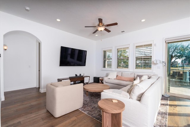 living room featuring dark hardwood / wood-style floors and ceiling fan