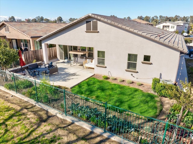 back of property with a patio and a yard