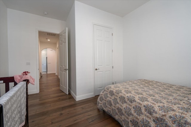 bedroom with dark hardwood / wood-style floors