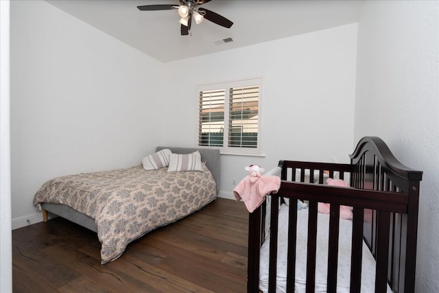 bedroom with ceiling fan and dark hardwood / wood-style flooring