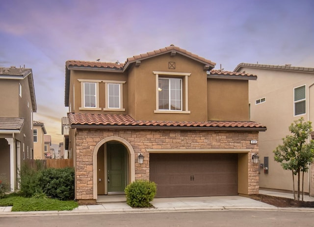 mediterranean / spanish-style home featuring a garage