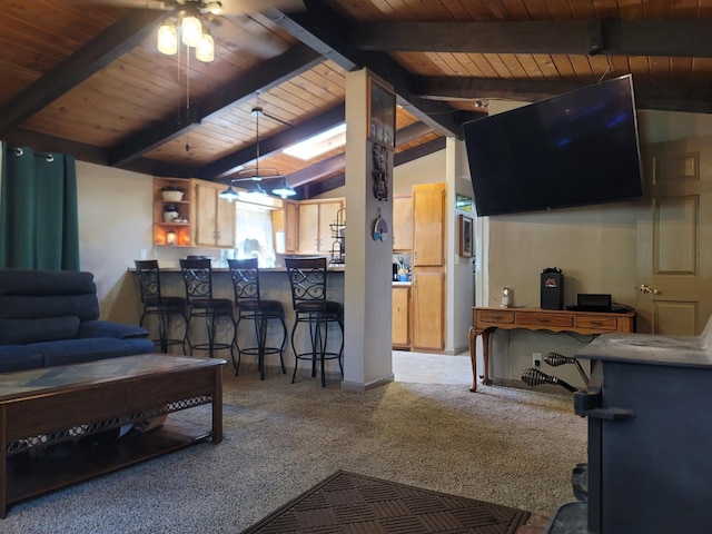 carpeted living room with a ceiling fan, wood ceiling, and vaulted ceiling with beams