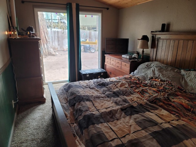 bedroom with vaulted ceiling and carpet flooring