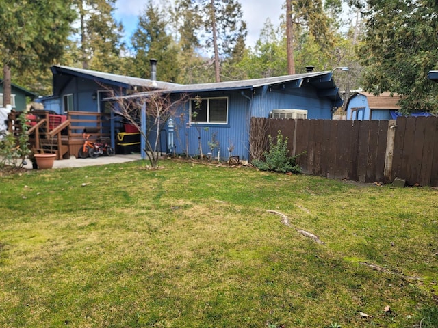 exterior space featuring a front lawn and fence