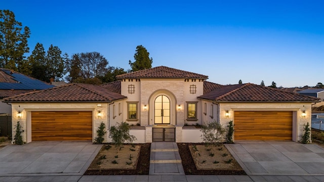 mediterranean / spanish house with a garage