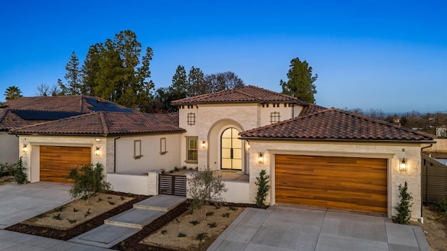 mediterranean / spanish-style home featuring a garage